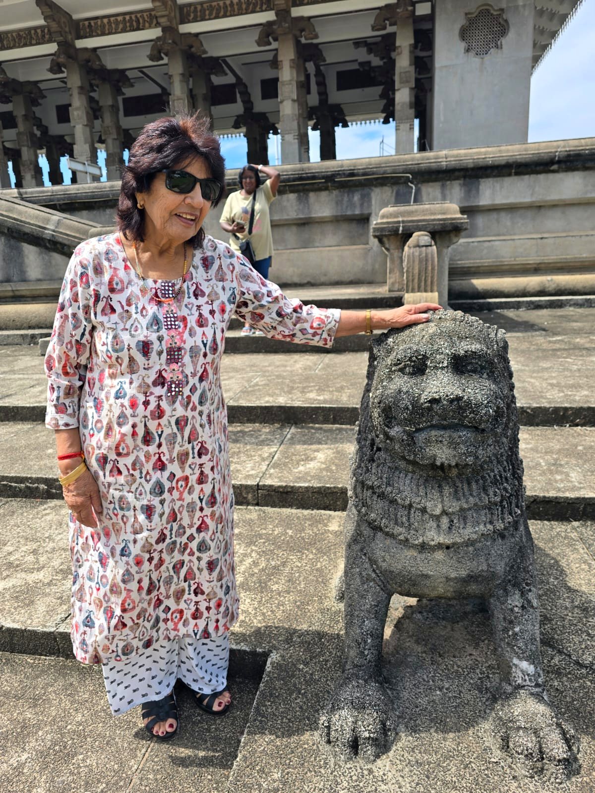 Guest beside an ancient stone lion