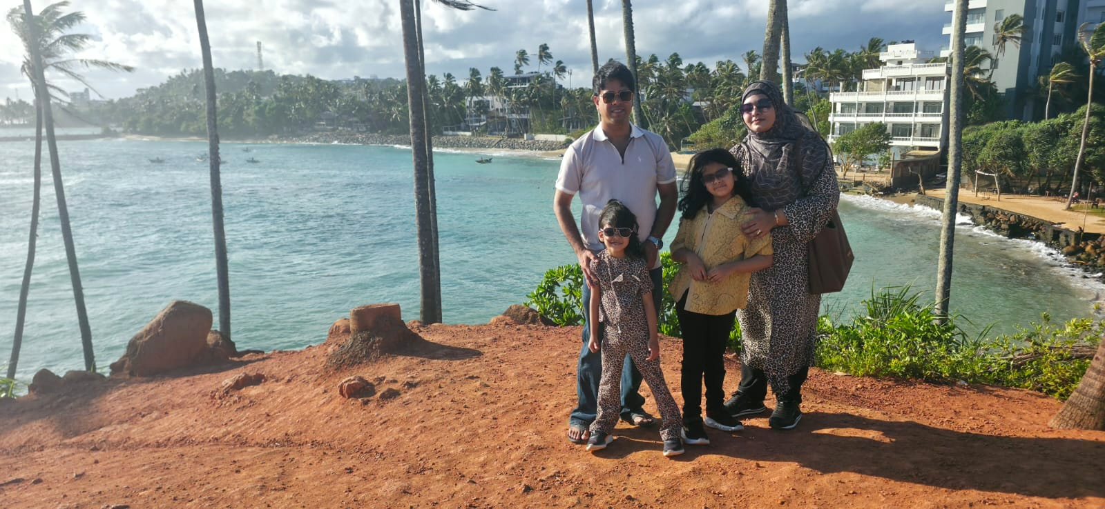 Family on Coconut Tree Hill above the sea