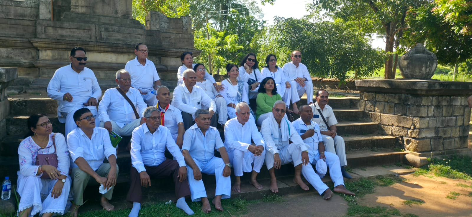 A pilgrim group dressed in white at a sacred site